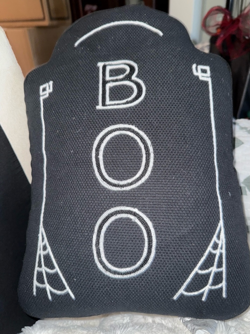 Black  tombstone shaped “BOO” Halloween pillow.